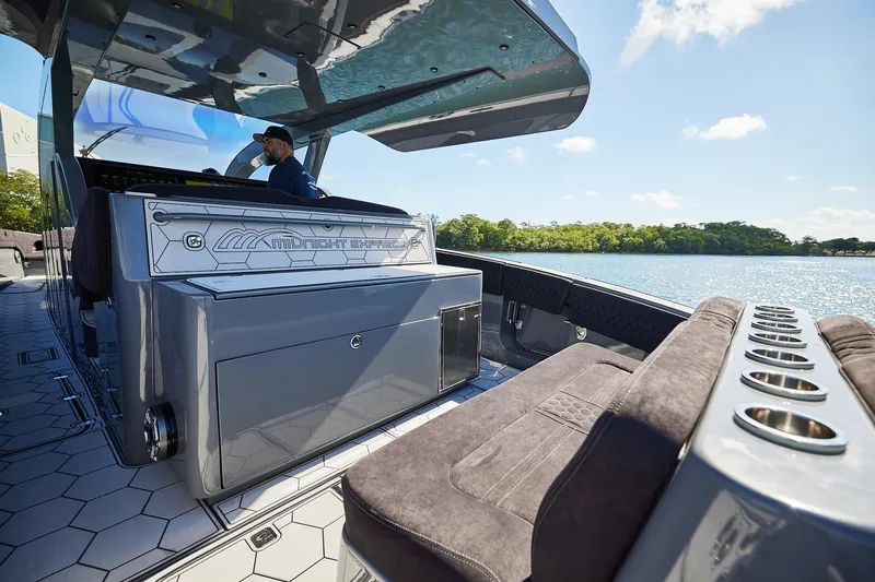 Slide: The Image of Luxury Midnight Express 52' Vitesse boat interior with sleek design and scenic water view. - 12