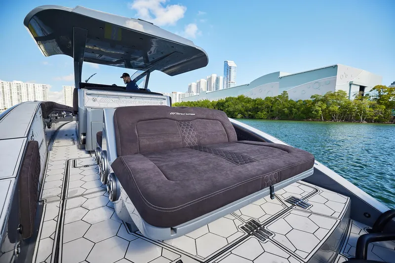 Slide: The Image of Luxury Midnight Express 52' Vitesse yacht with sleek design, cruising near modern cityscape. - 15