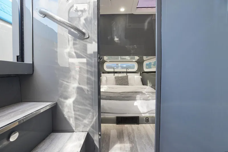 Slide: The Image of Luxurious cabin interior of Midnight Express 52' Vitesse yacht, featuring a cozy bed and modern design. - 23