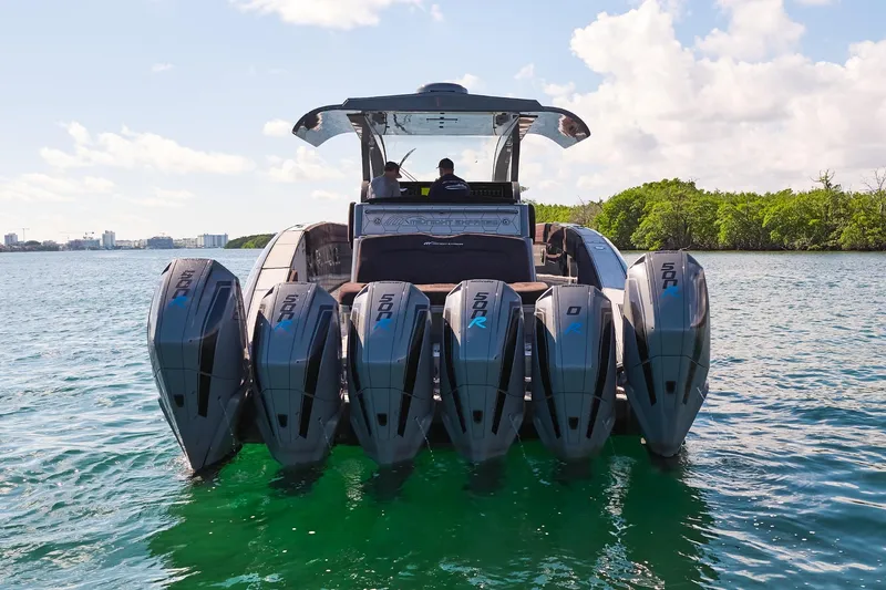 Slide: The Image of Midnight Express 52' Vitesse boat with six powerful outboard engines on a sunny day. - 5