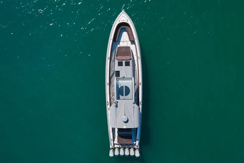 Slide: The Image of Aerial view of Midnight Express 52' Vitesse yacht on clear turquoise water. - 6