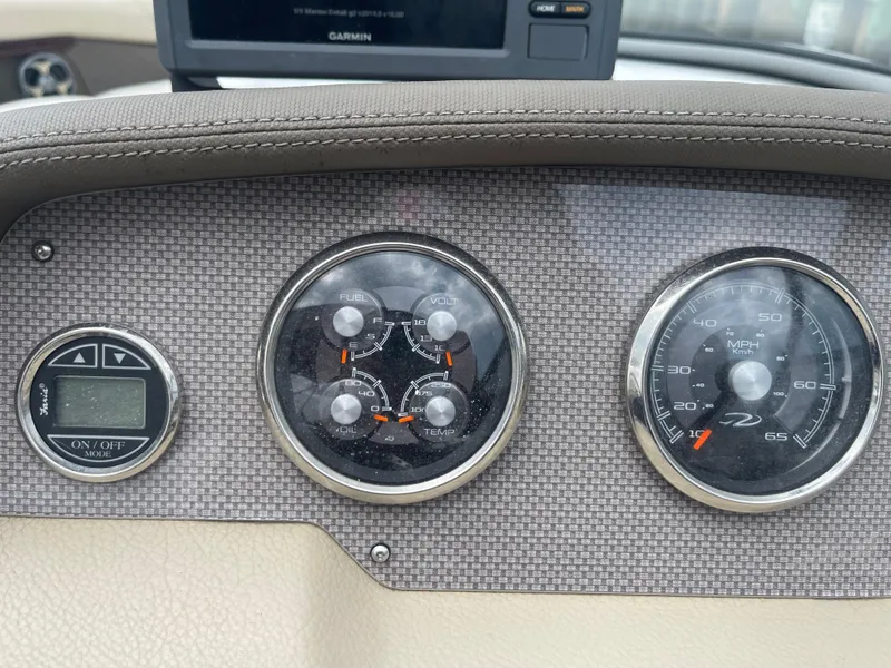 Slide: The Image of Dashboard of 2014 Regal 2700 Bowrider with gauges and Garmin display. - 18