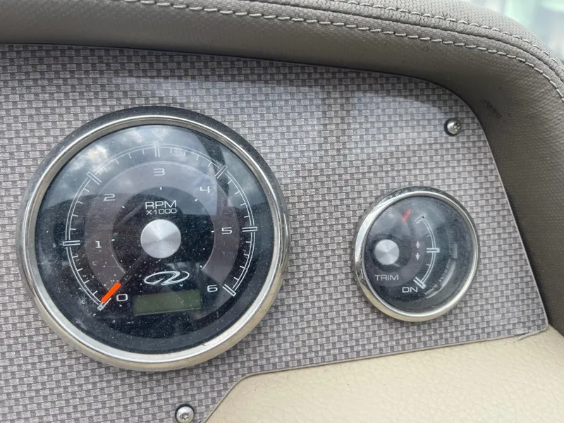 Slide: The Image of Dashboard of 2014 Regal 2700 Bowrider showing RPM and trim gauges. - 19