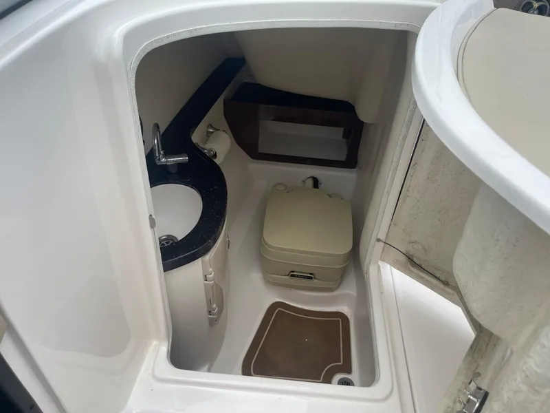 Slide: The Image of 2014 Regal 2700 Bowrider boat interior with compact bathroom and sink. - 23