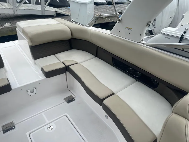 Slide: The Image of 2014 Regal 2700 Bowrider boat interior with beige seating and white deck. - 24
