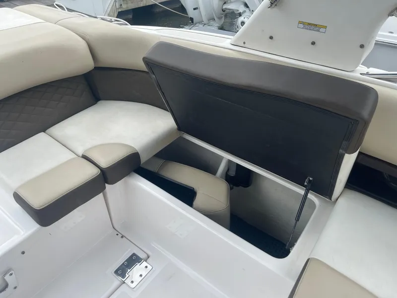 Slide: The Image of 2014 Regal 2700 Bowrider interior seating with storage compartment open. - 27