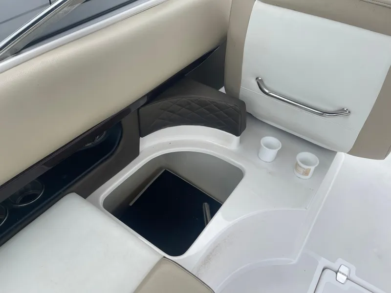 Slide: The Image of 2014 Regal 2700 Bowrider interior with cup holders and seating area. - 28