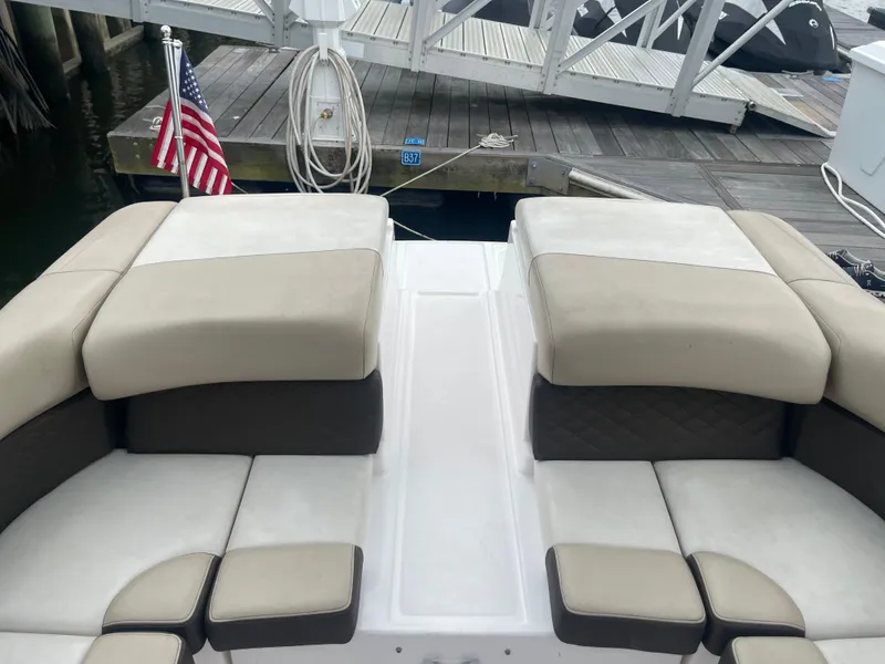 Slide: The Image of 2014 Regal 2700 Bowrider boat interior with beige seating at dock. - 29