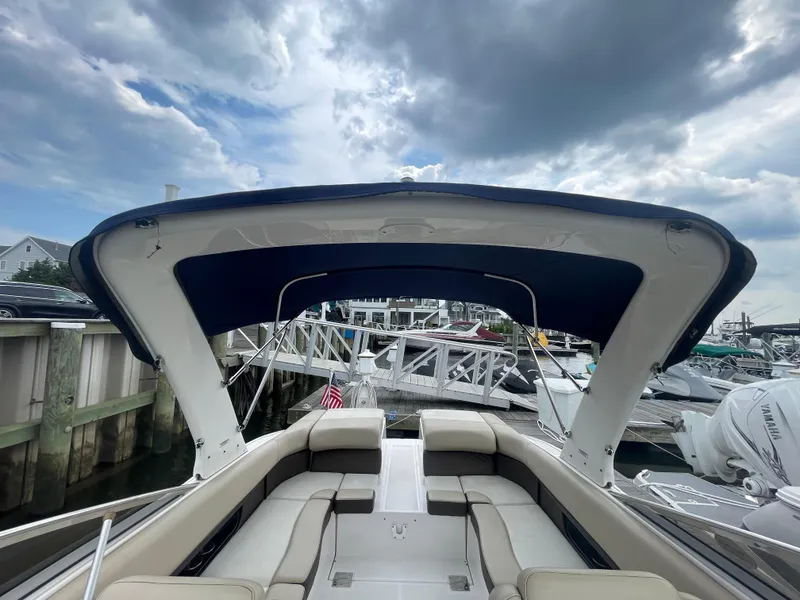 Slide: The Image of 2014 Regal 2700 Bowrider boat docked under cloudy sky. - 31