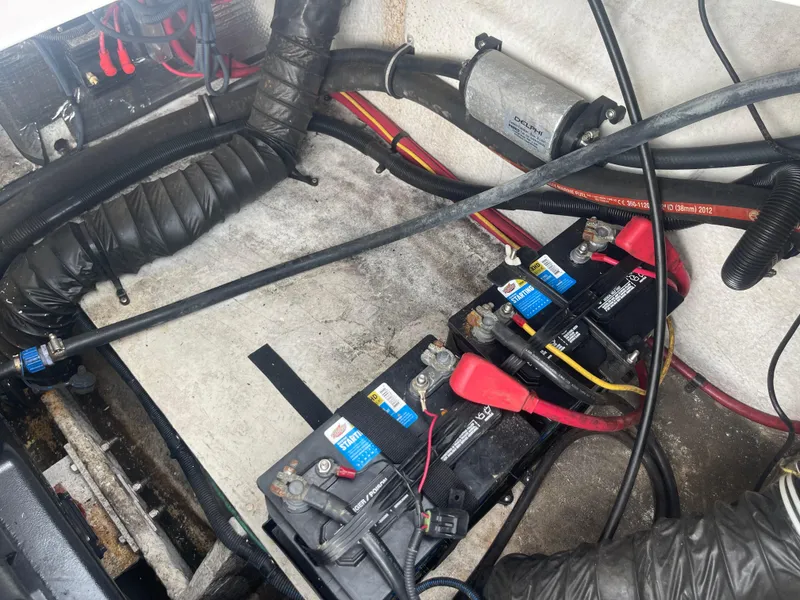 Slide: The Image of 2014 Regal 2700 Bowrider boat battery compartment with wiring and components. - 36