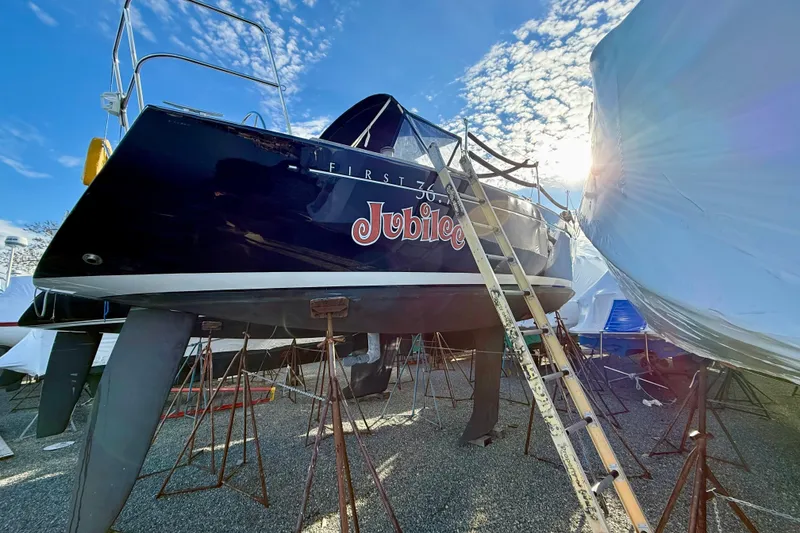 Slide: The Image of 2005 Beneteau First 36.7 sailboat on stands, under clear blue sky. - 12