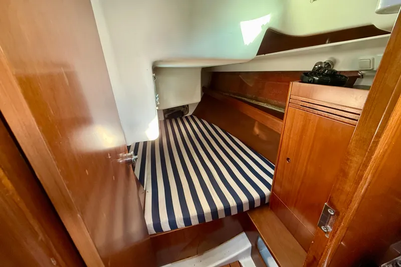 Slide: The Image of Cozy cabin interior of 2005 Beneteau First 36.7 sailboat with striped bedding. - 14