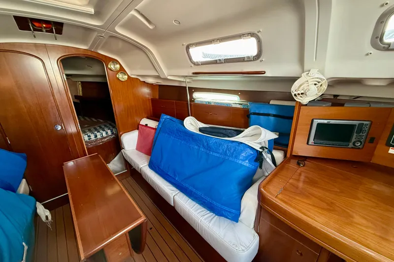 Slide: The Image of Interior of 2005 Beneteau First 36.7 sailboat with wood finish and seating area. - 17