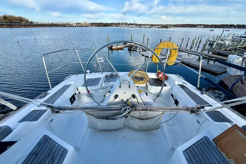 Slide: The Image of 2005 Beneteau First 36.7 sailboat docked at marina, featuring spacious cockpit and steering wheel. - 6