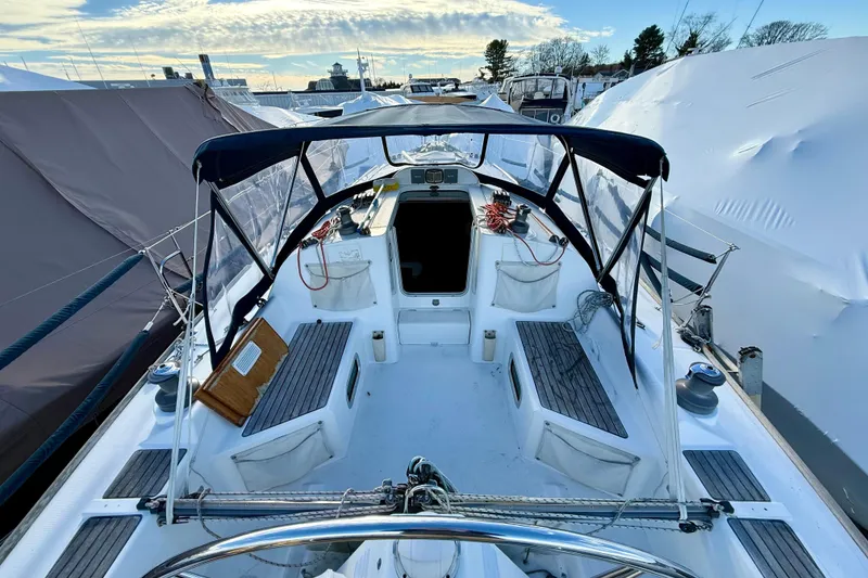 Slide: The Image of 2005 Beneteau First 36.7 sailboat cockpit with canopy, docked under clear sky. - 7