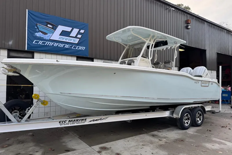 The Image of 2026 Key West 263 FS boat on trailer outside marine shop. - 0