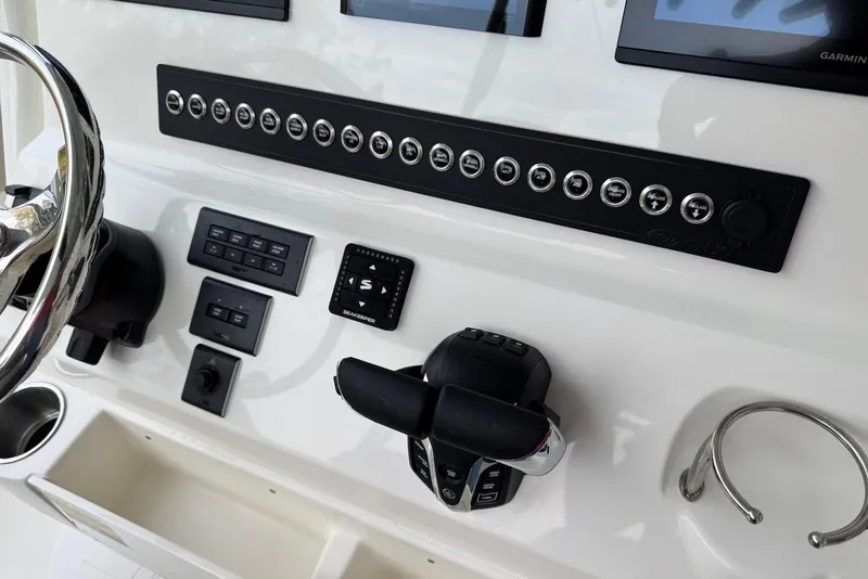 Slide: The Image of 2026 Key West 263 FS boat dashboard with controls and steering wheel. - 14