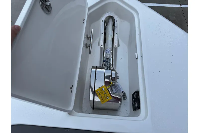 Slide: The Image of Anchor compartment of 2026 Key West 263 FS boat, featuring a secured anchor and chain. - 25