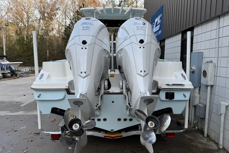 Slide: The Image of 2026 Key West 263 FS boat with dual 300 V6 engines, docked outdoors. - 3