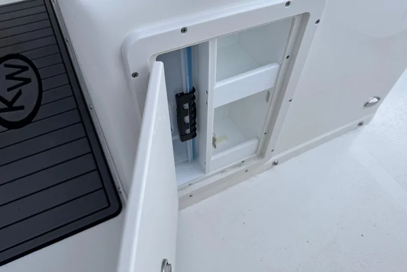 Slide: The Image of Open storage compartment on 2026 Key West 263 FS boat, featuring sleek design and KW logo. - 30