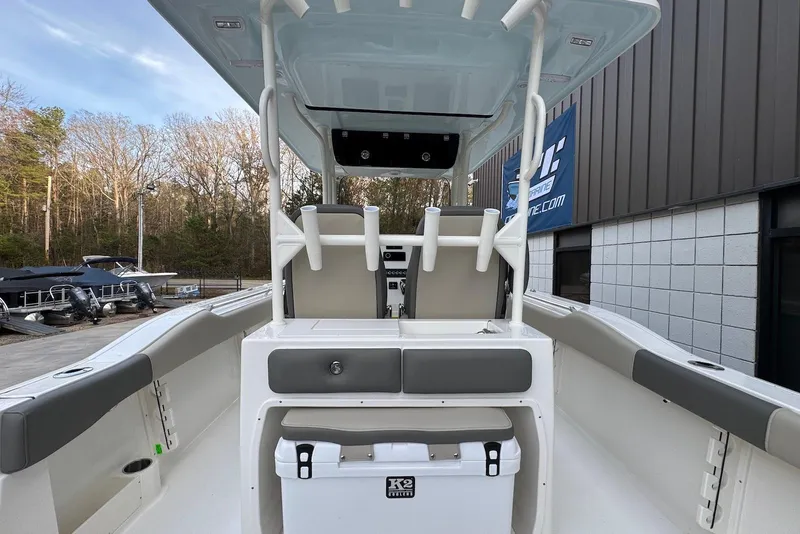Slide: The Image of 2026 Key West 263 FS boat interior with seating and storage, docked outdoors. - 36