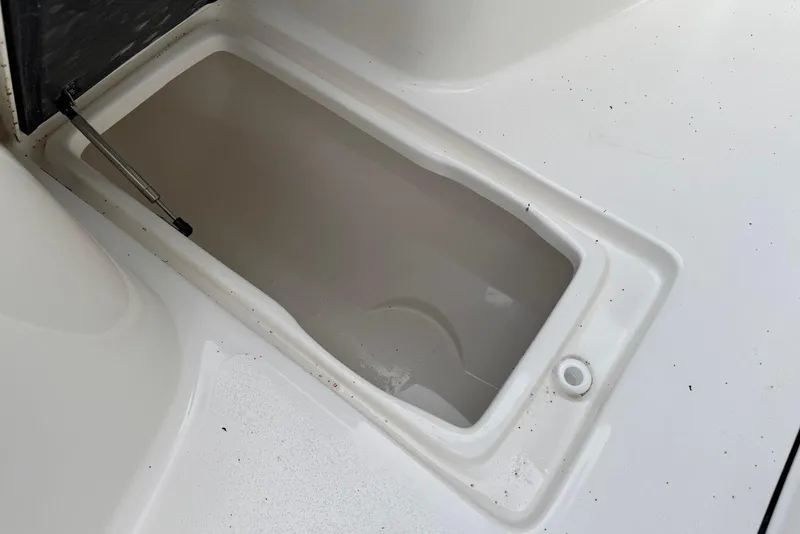Slide: The Image of Open storage compartment on 2026 Key West 263 FS boat, featuring a clean white interior. - 38