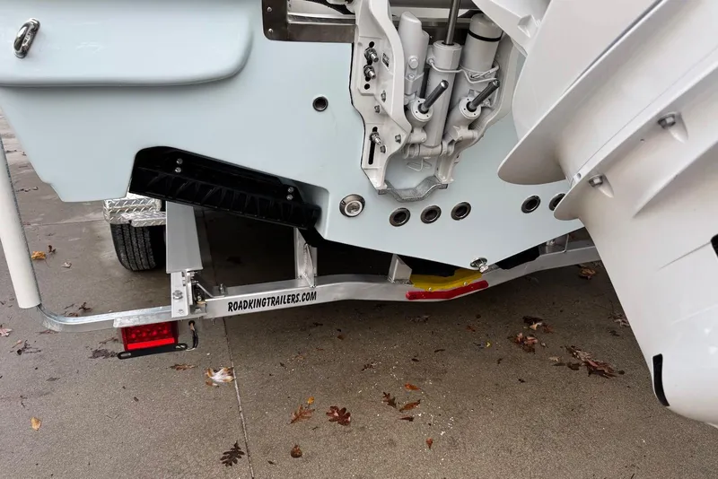 Slide: The Image of 2026 Key West 263 FS boat on Road King trailer, showcasing engine mount and trailer details. - 4