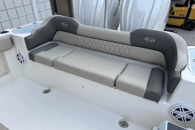 Slide: The Image of 2026 Key West 263 FS boat with cushioned seating and integrated speakers. - 9