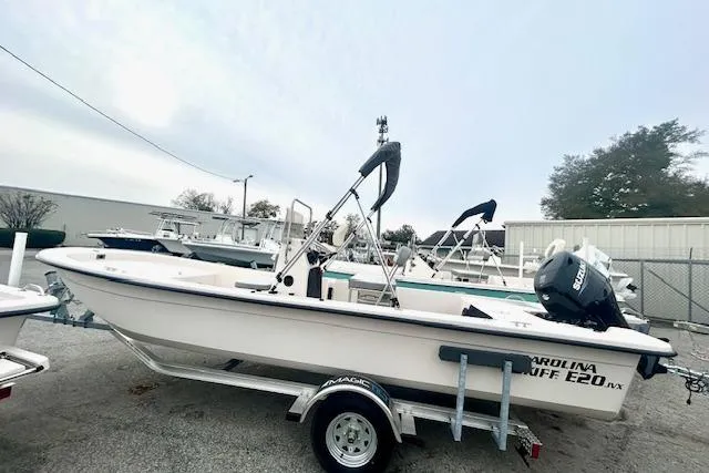 The Image of 2026 Carolina Skiff E20 JVX CC boat on trailer, parked outdoors. - 1
