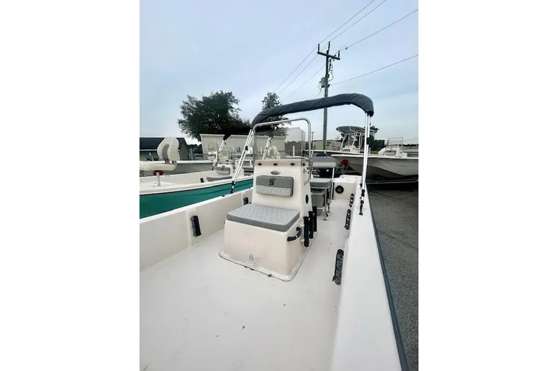 Slide: The Image of 2026 Carolina Skiff E20 JVX CC boat with center console and seating, parked outdoors. - 3