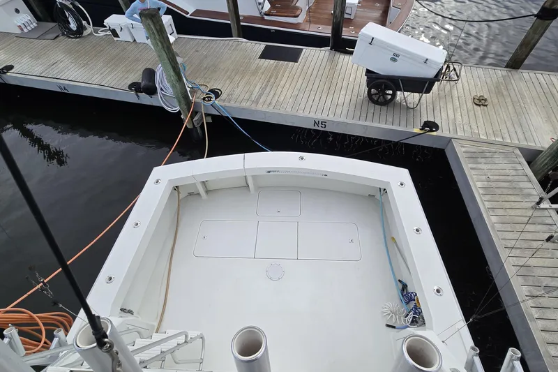 Slide: The Image of 1989 Viking 45 Convertible boat docked at marina, view of spacious deck area. - 12