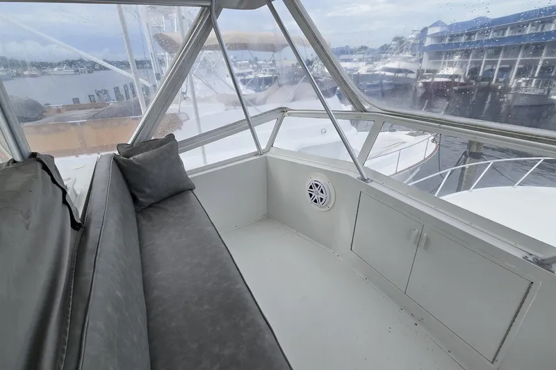 Slide: The Image of 1989 Viking 45 Convertible yacht interior with cushioned seating and marina view. - 20
