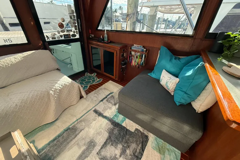 Slide: The Image of Cozy interior of 1989 Viking 45 Convertible yacht with seating, pillows, and decor. - 28