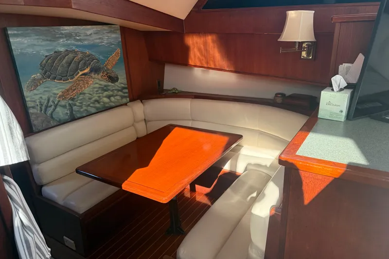 Slide: The Image of 1989 Viking 45 Convertible yacht interior with dining area and turtle artwork. - 30