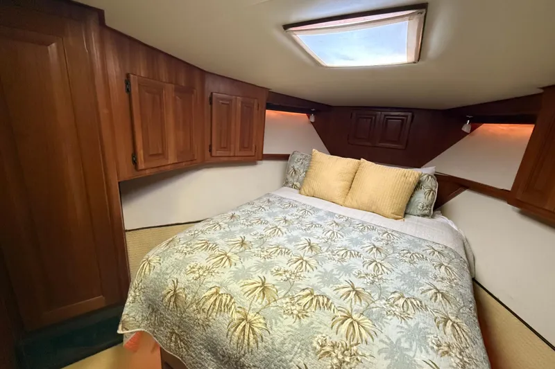Slide: The Image of Cozy bedroom in 1989 Viking 45 Convertible yacht with wood cabinets and skylight. - 31