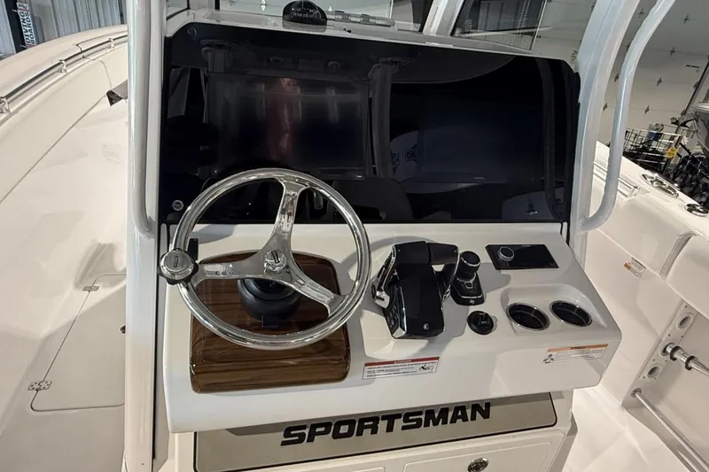 Slide: The Image of 2025 Sportsman Open 322 Center Console helm with steering wheel and controls. - 10