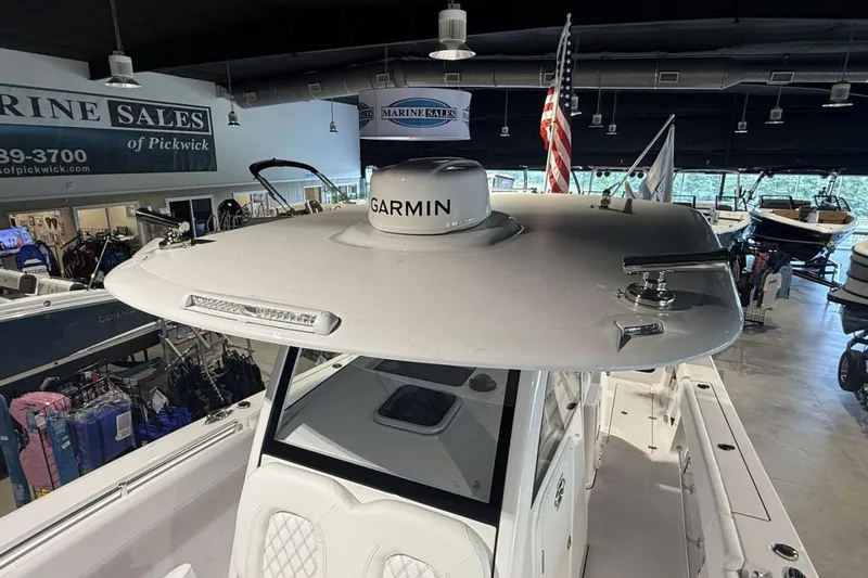 Slide: The Image of 2025 Sportsman Open 322 Center Console boat displayed in a showroom with Garmin equipment. - 15