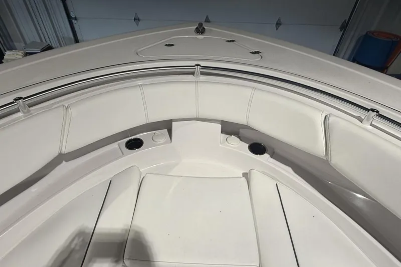 Slide: The Image of 2025 Sportsman Open 322 Center Console boat interior with white cushioned seating. - 17