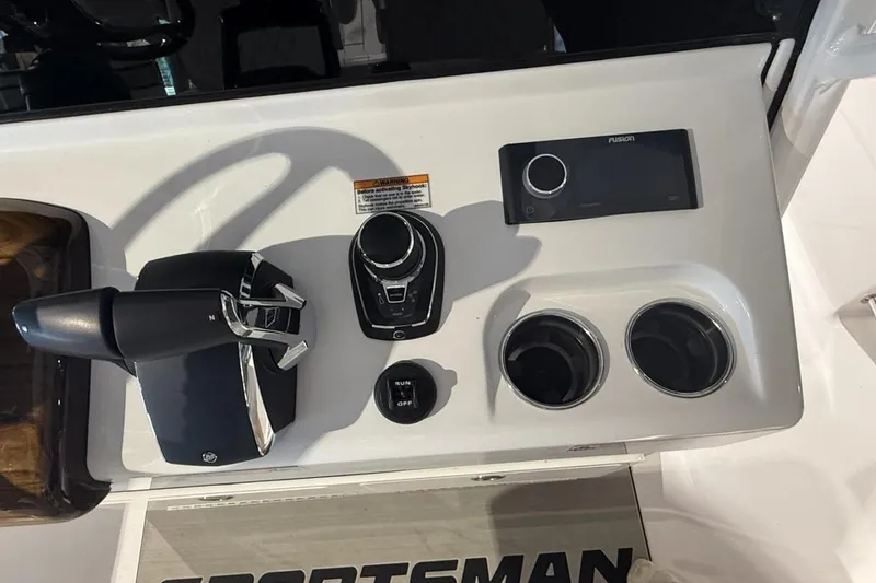 Slide: The Image of 2025 Sportsman Open 322 Center Console dashboard with controls and cup holders. - 22