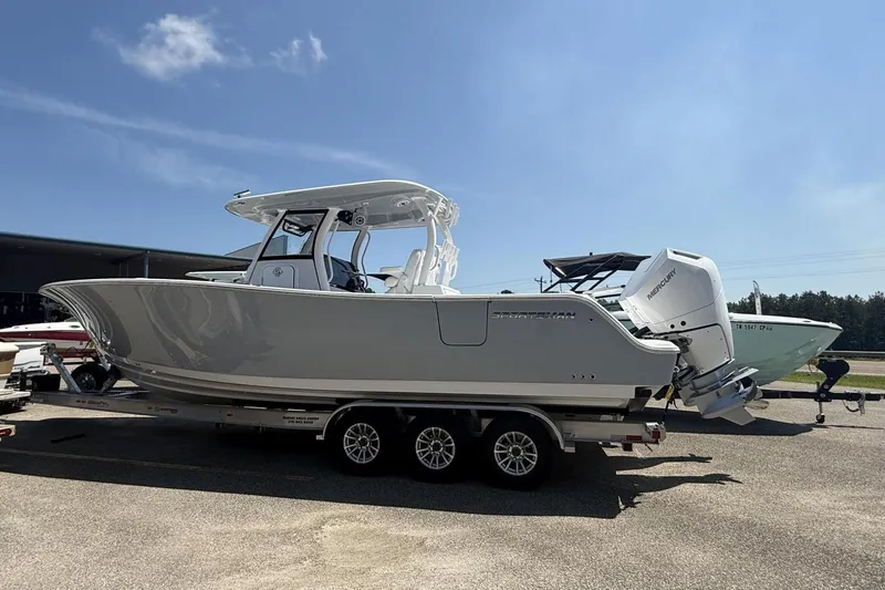 Slide: The Image of 2025 Sportsman Open 322 Center Console boat on trailer under clear sky. - 24