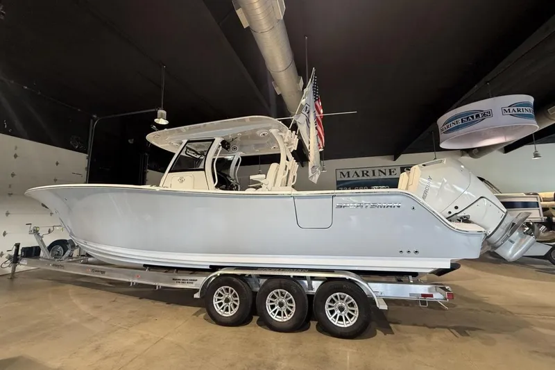 Slide: The Image of 2025 Sportsman Open 322 Center Console boat on trailer in showroom. - 3