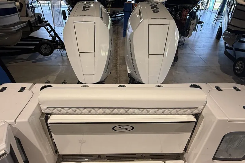 Slide: The Image of 2025 Sportsman Open 322 Center Console with dual Mercury outboard engines in showroom. - 5