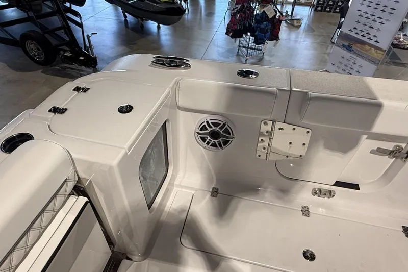 Slide: The Image of 2025 Sportsman Open 322 Center Console boat interior with speaker and storage compartments. - 8