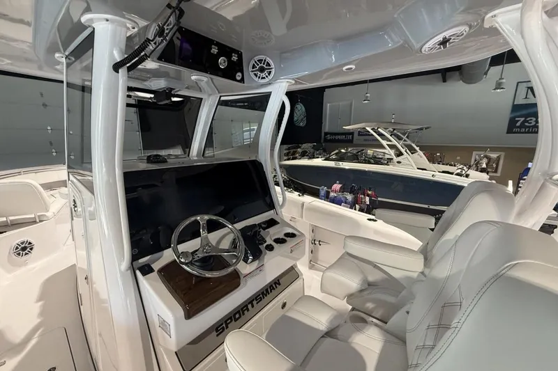 Slide: The Image of 2025 Sportsman Open 322 Center Console boat interior with modern steering and seating. - 9