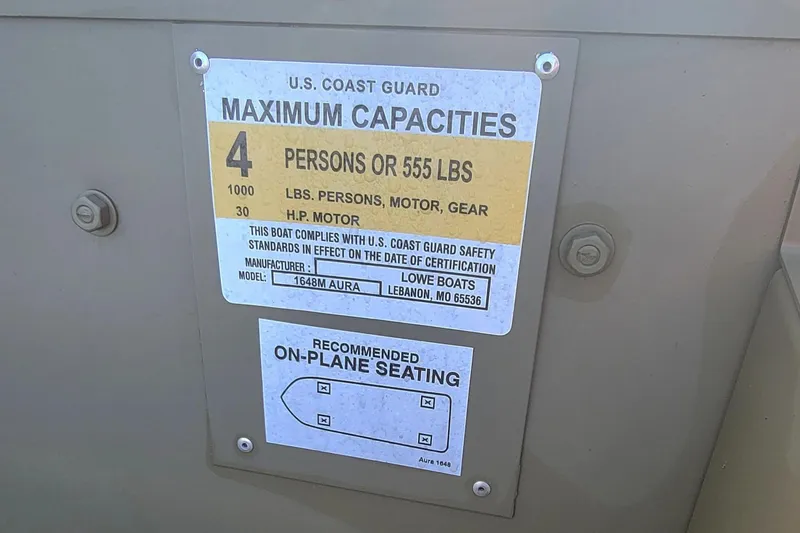Slide: The Image of 2025 Lowe L1648 Jon boat capacity label, showing maximum 4 persons or 555 lbs. - 6