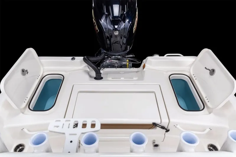 Slide: The Image of Manufacturer Provided Image: 2026 Skeeter SX2350 boat with open storage compartments and motor, showcasing fishing amenities. - 11
