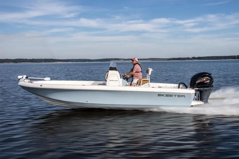 Slide: The Image of Manufacturer Provided Image: 2026 Skeeter SX2350 boat cruising on a calm lake under a clear blue sky. - 3