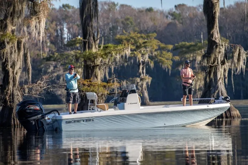 Slide: The Image of Manufacturer Provided Image: 2026 Skeeter SX2350 boat on a serene lake with two people fishing. - 4