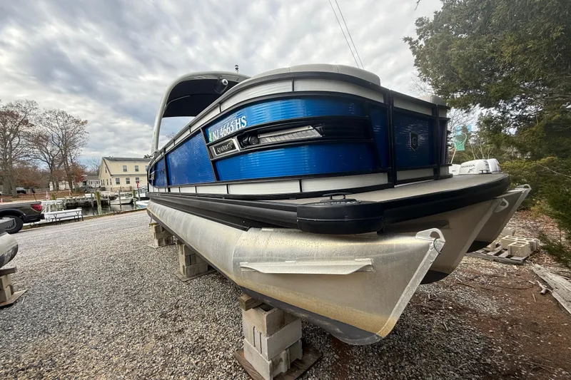 Slide: The Image of Interior of 2023 Godfrey AquaPatio 255 ULC boat with steering wheel and control panel. - 13