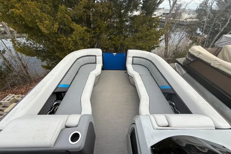 Slide: The Image of Interior of 2023 Godfrey AquaPatio 255 ULC pontoon boat with seating and speaker. - 21